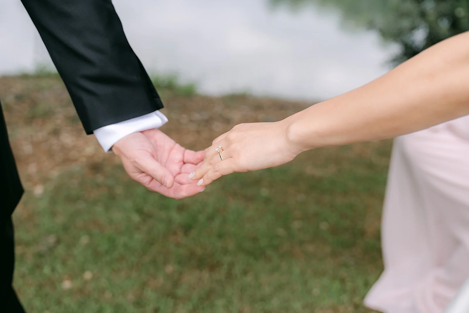 Kristine reaching for William's hand before the first look