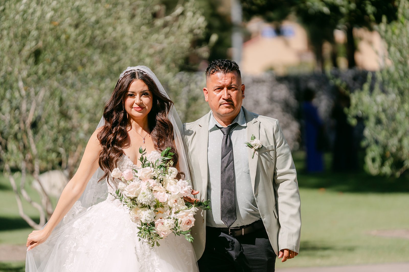 Sandra walking down the aisle with her bouquet at Coyote Hills Golf Course.