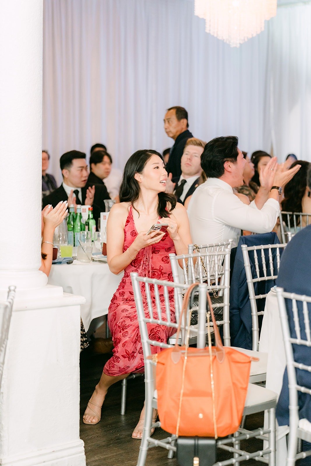 Guests filming the grand entrance from their tables