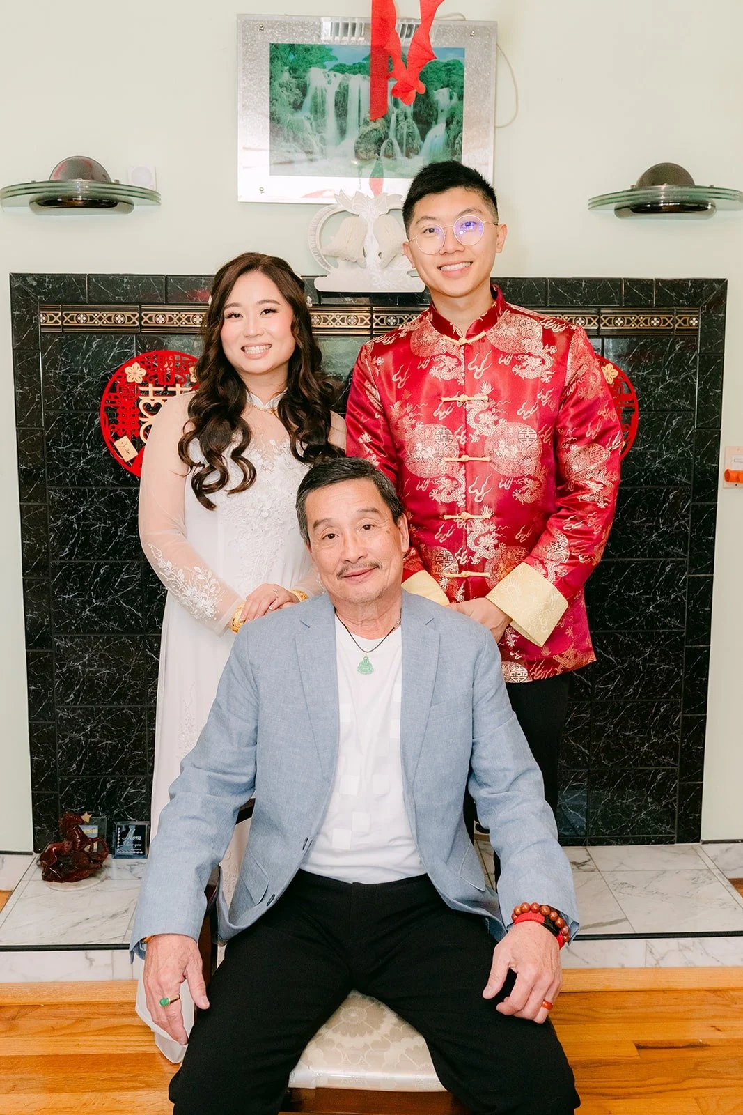 Shayna and Robert pose behind a seated family member after the tea ceremony