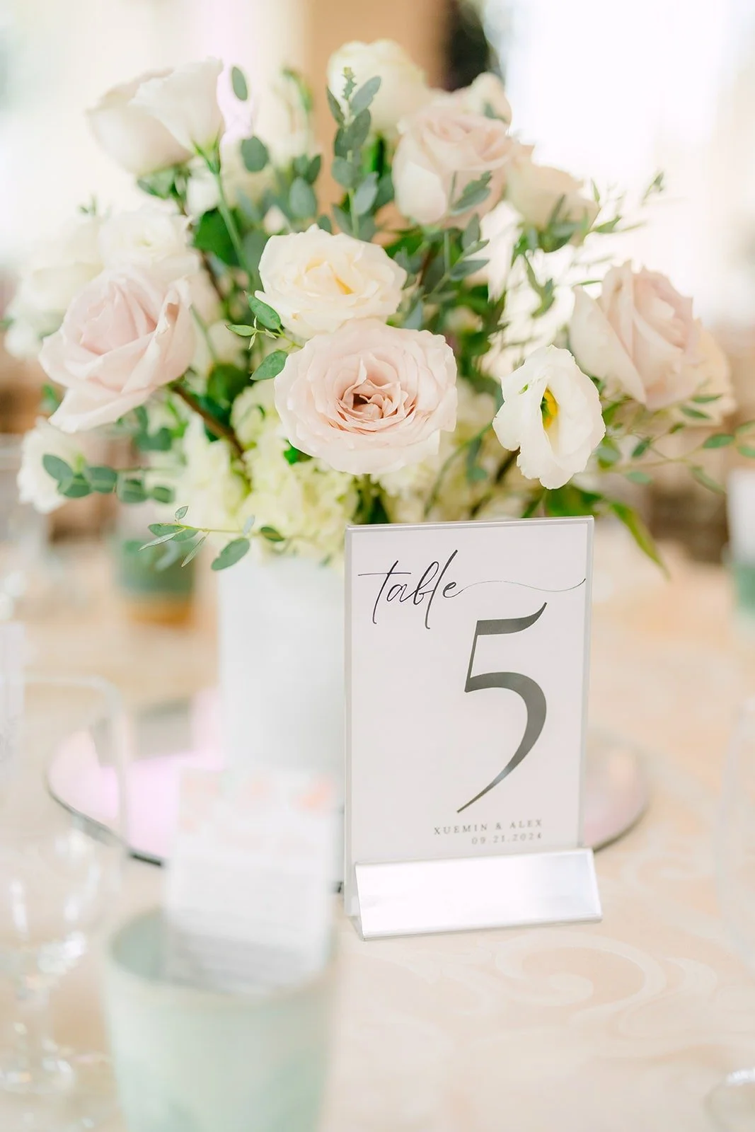 White rose centerpiece with table number five