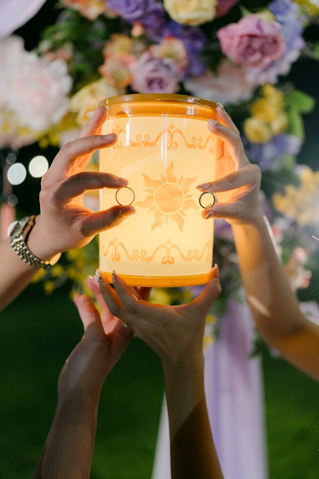 Hands holding a glowing Tangled lantern.