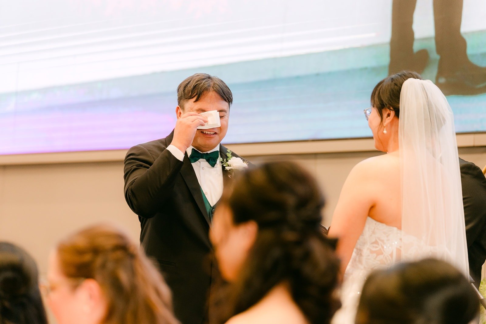 James wiping away tears as Stella speaks during the ceremony