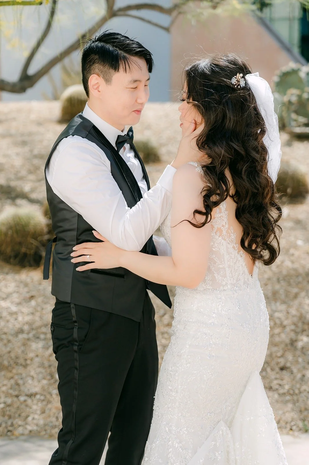 James in his vest holding Emily close among the cactus garden