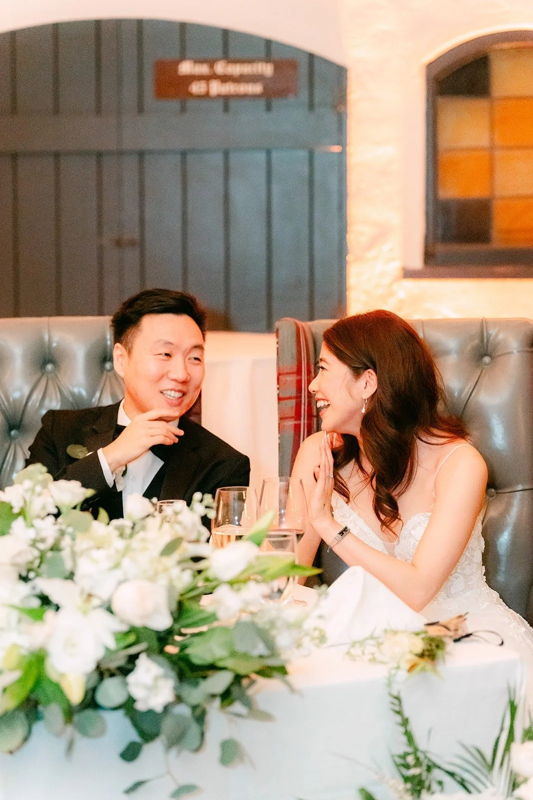 Valerie and Jason laughing during the speeches