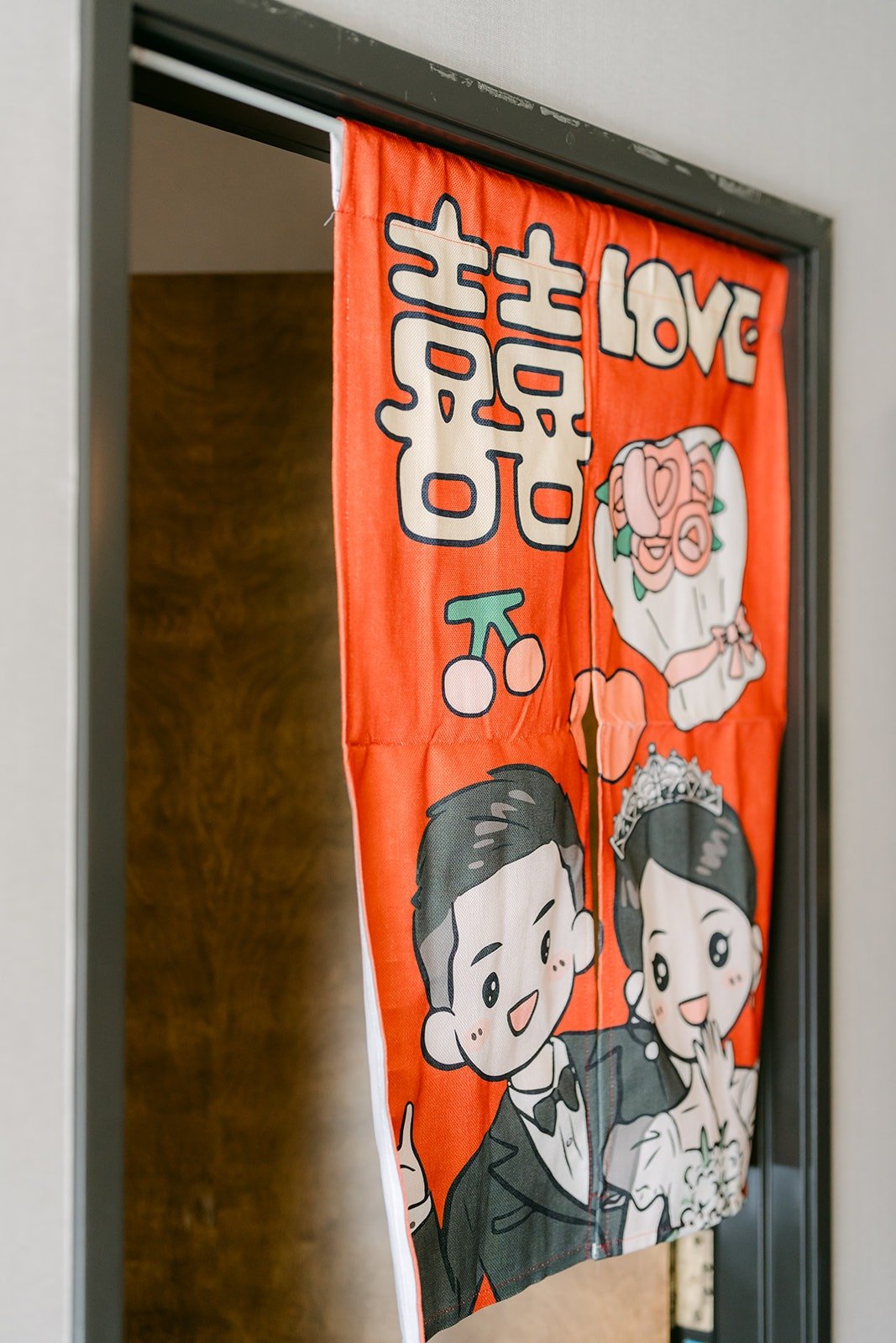 A hand painted door banner with a cartoon of the couple at the DoubleTree by Hilton Claremont
