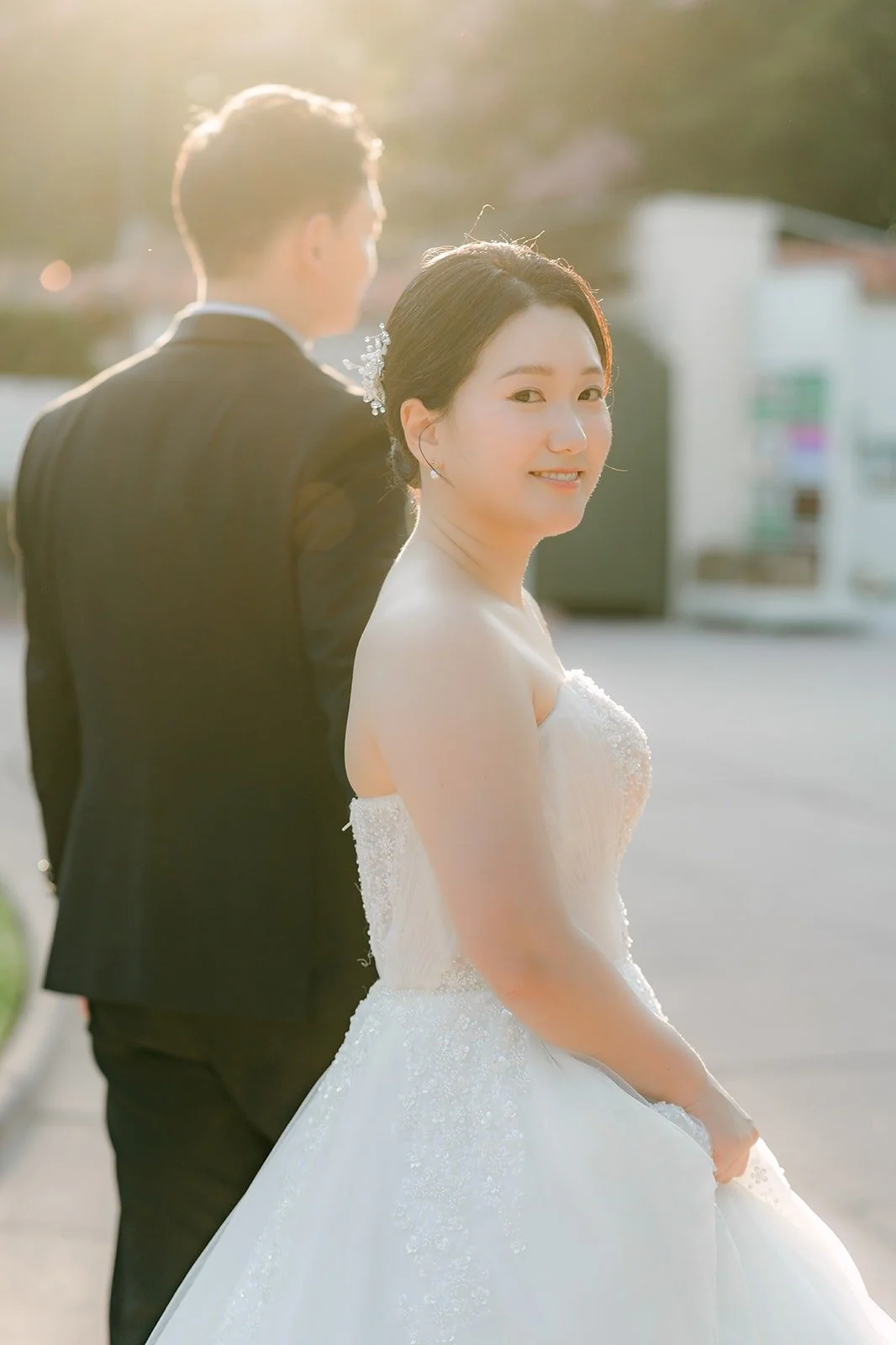 Amy smiling over Sam's shoulder in soft light