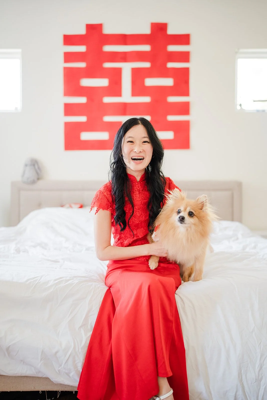 Valerie sitting on the bed with Kohmie.