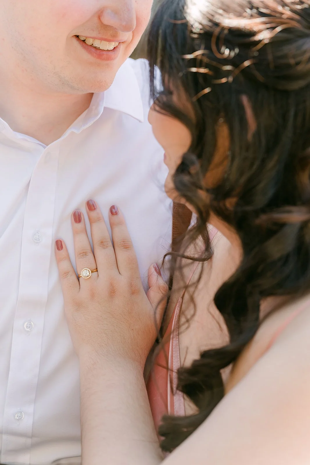 Saira's engagement ring as she rests her hand on Matthew's chest, photographed by One and Only Production.