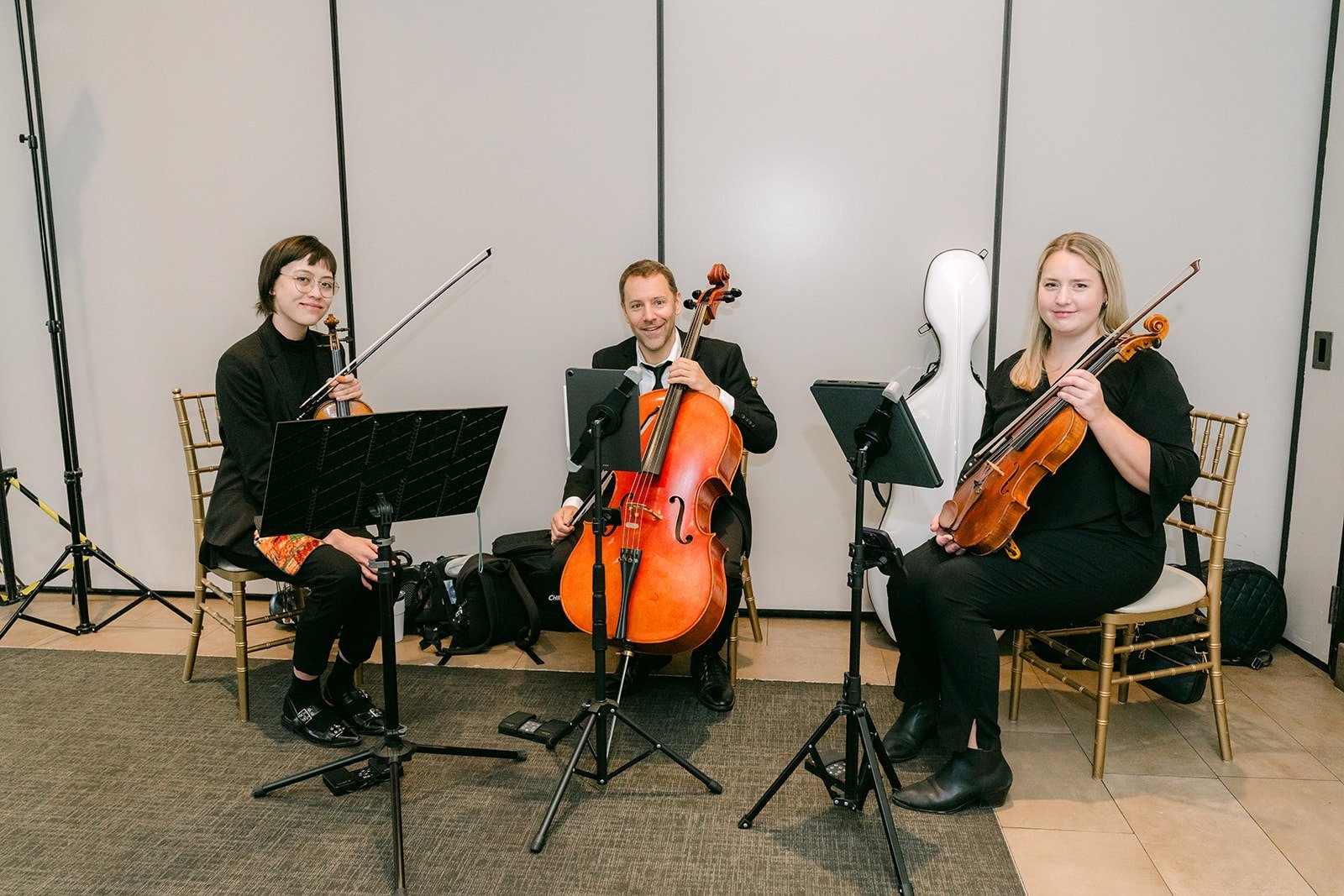 The string trio playing violin, cello and viola for guests