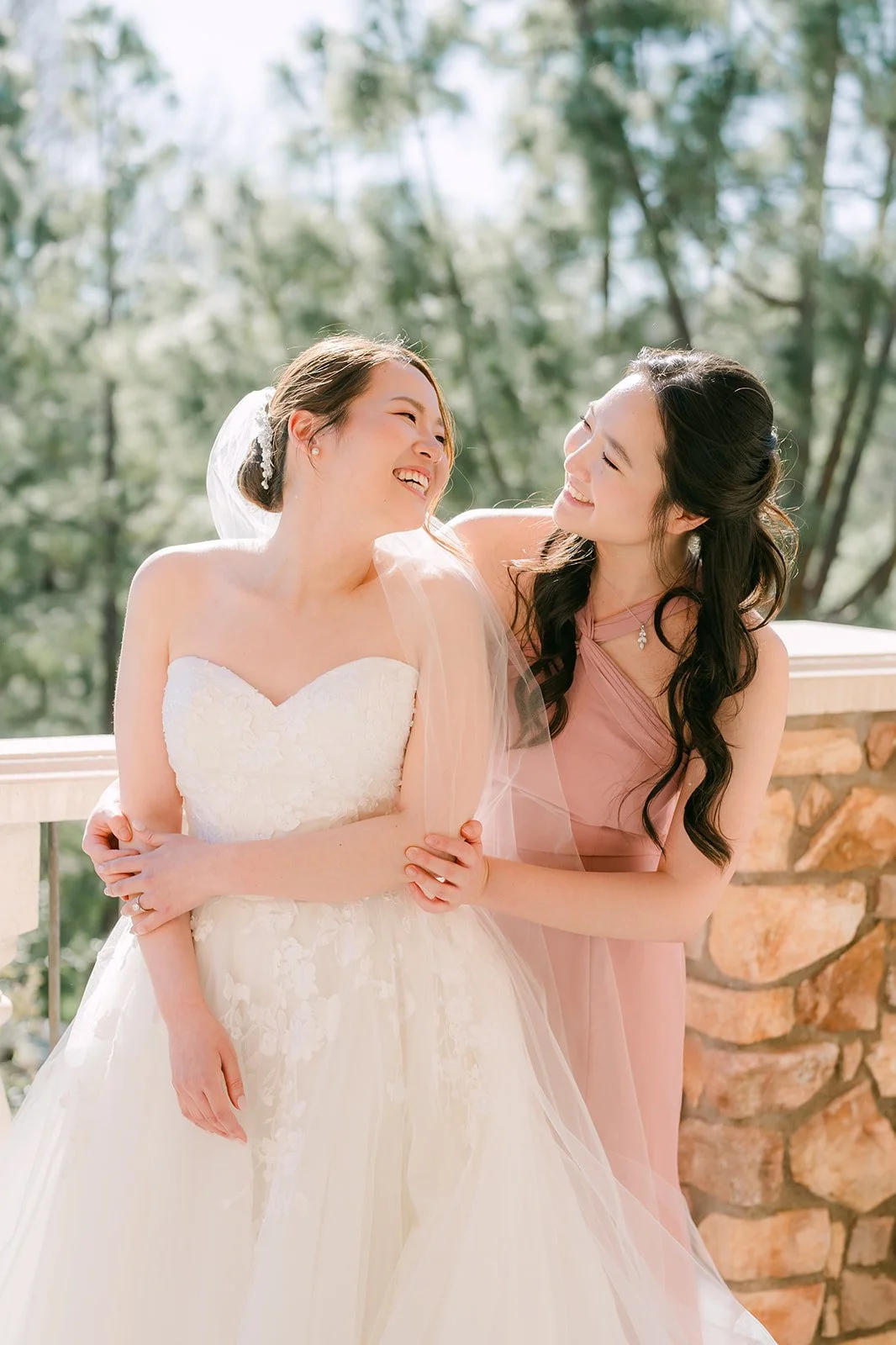 Victoria laughing with her sister on the Vellano Estate balcony