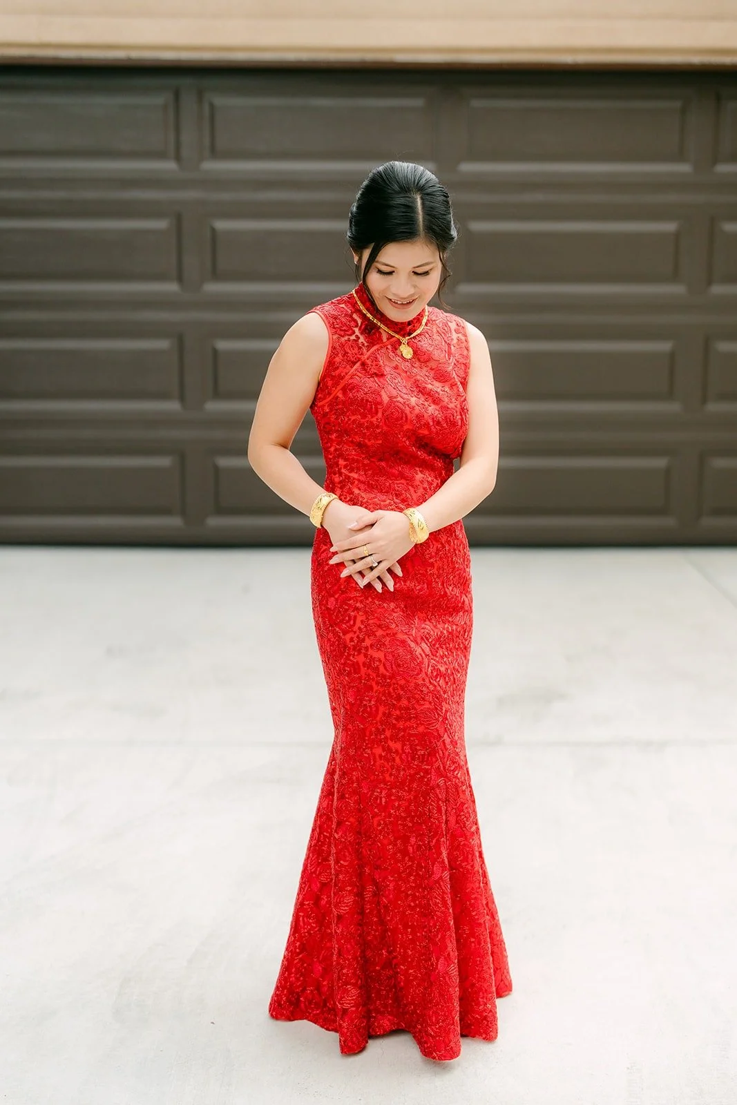 Xuemin in a red lace cheongsam and gold jewelry