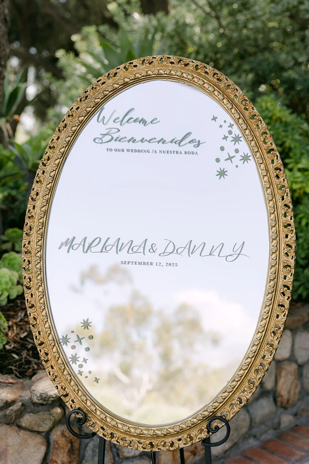 A gold mirror welcome sign for Mariana and Danny
