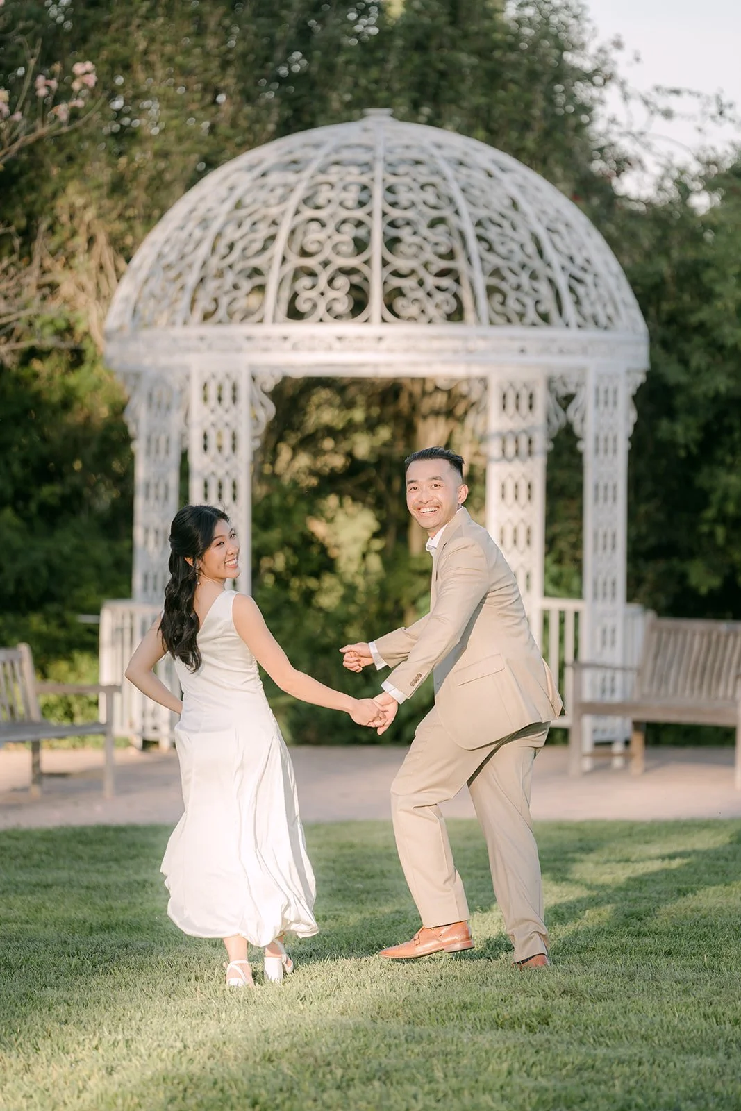 Vincent twirls Kim on the lawn by the gazebo.