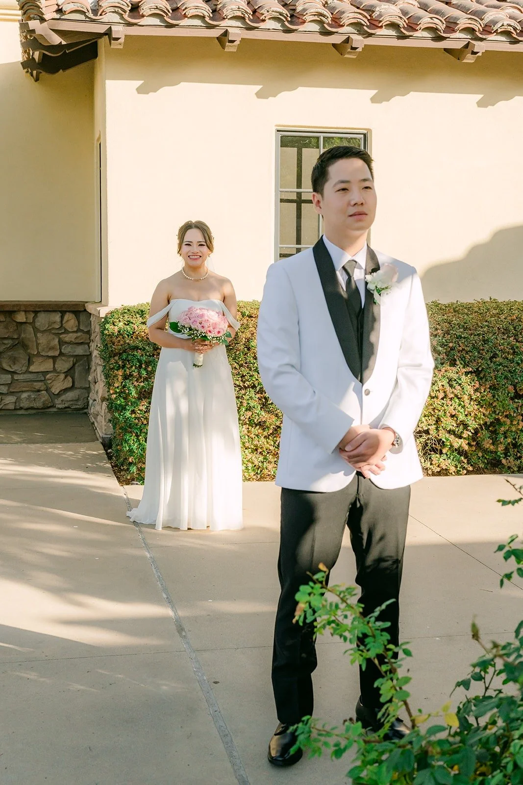 Ivy walking up behind Chungman for their first look