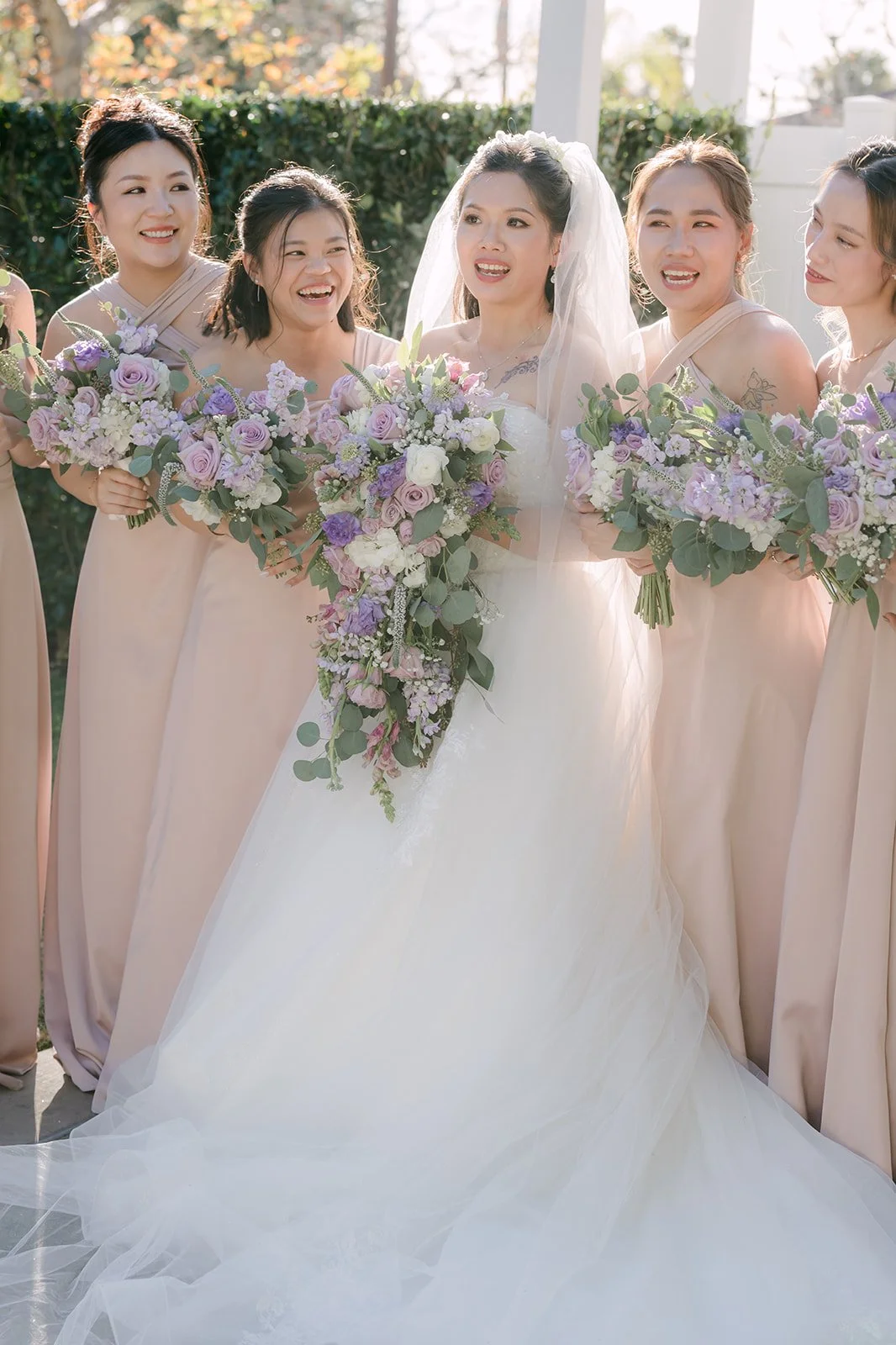 Kate surrounded by her bridesmaids and their lilac bouquets.