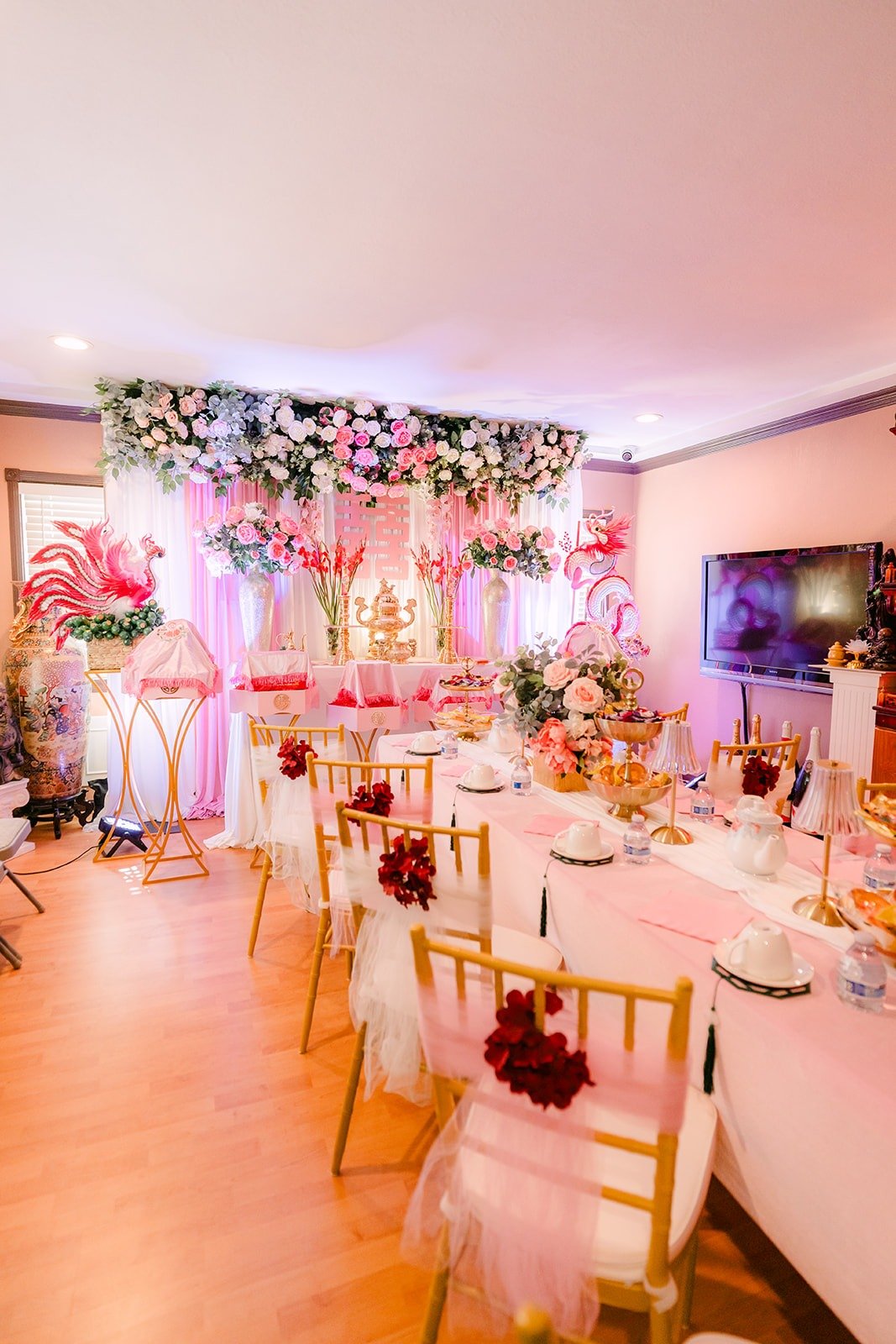 Tea ceremony setup with pink florals and gold tea set