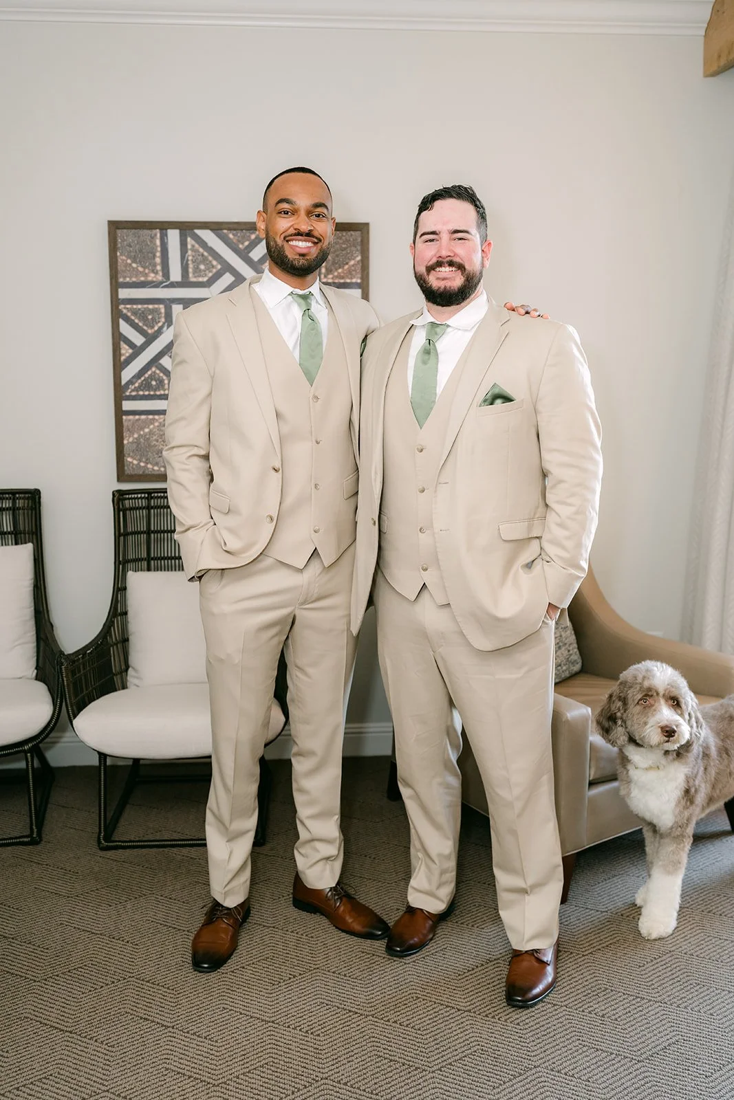 Cody and a groomsman in tan suits with Olive at their feet.