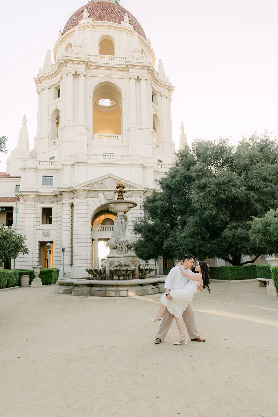 James spins Emily in the courtyard below the Pasadena City Hall dome, photographed by One and Only Production.