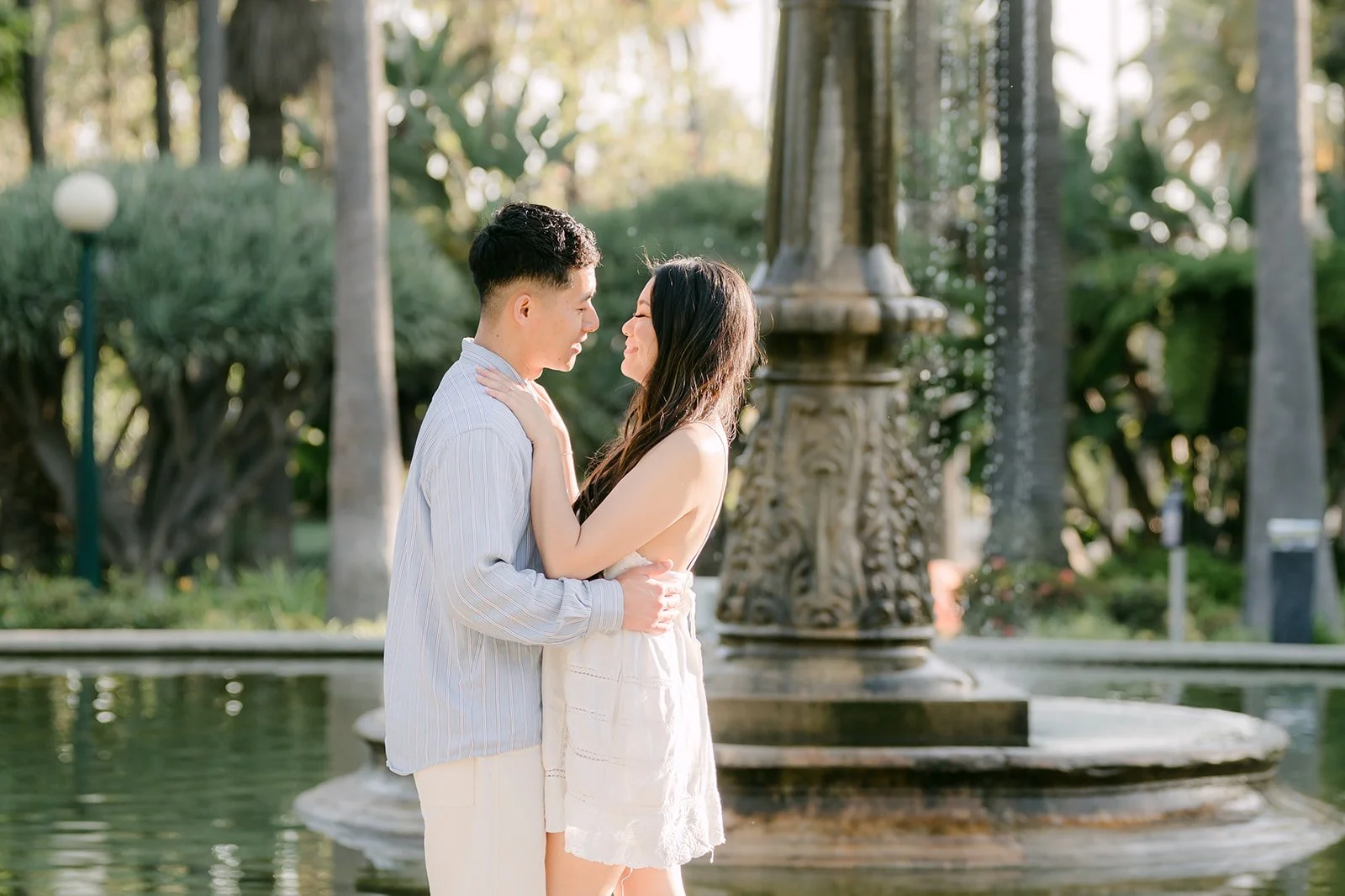 Jadee and Richard pose in front of the fountain at Will Rogers Memorial Park.