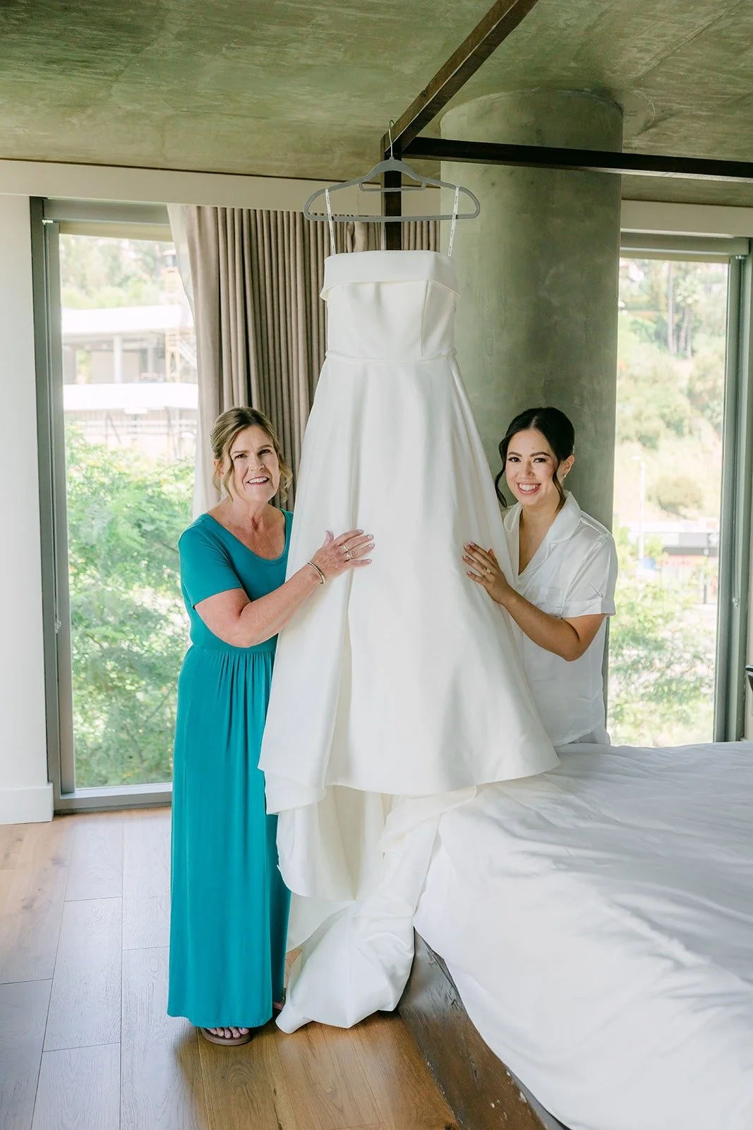 Bridesmaids holding up Brianna's strapless gown