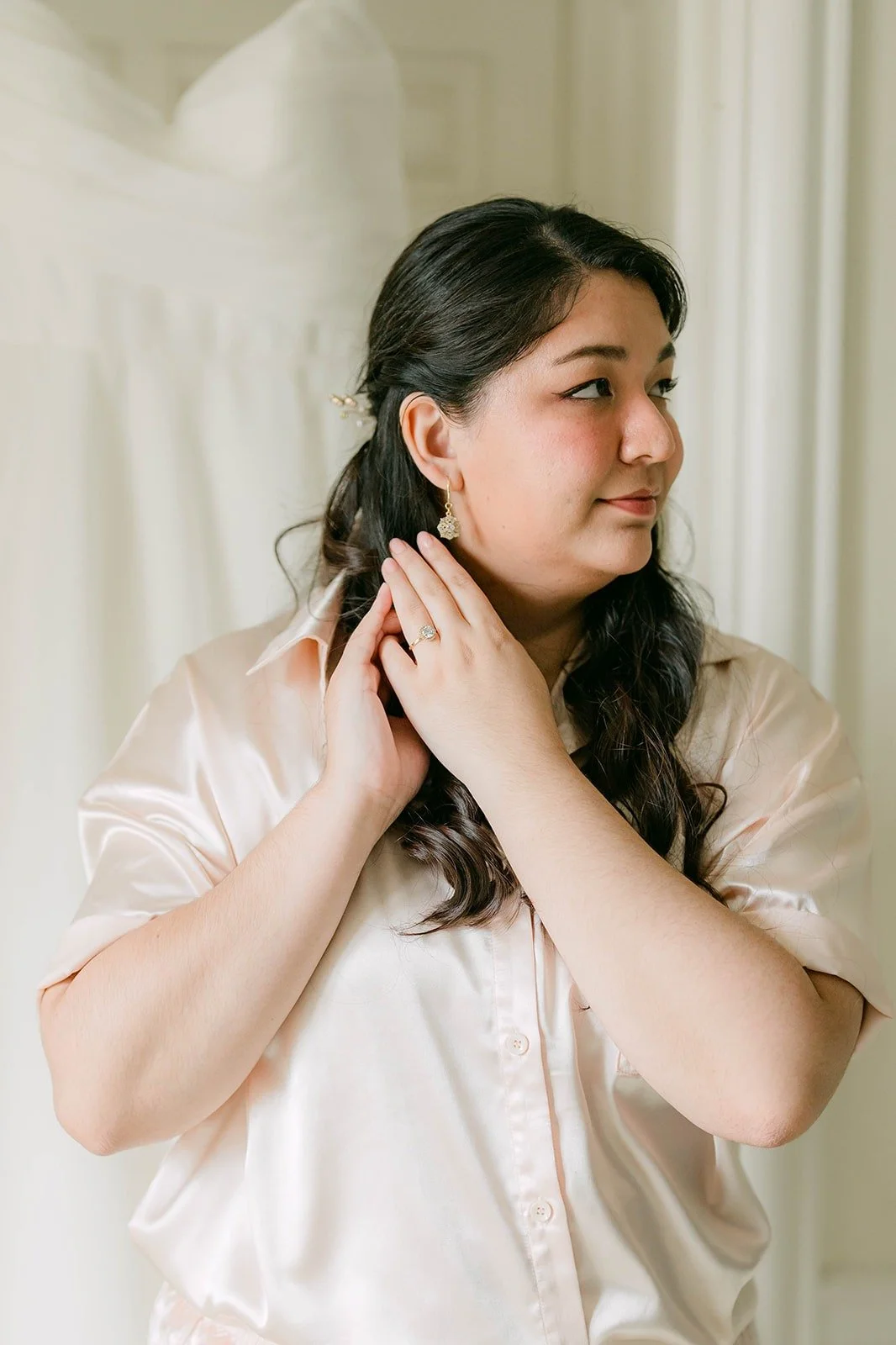 Saira in her pajamas in soft window light before putting on her dress