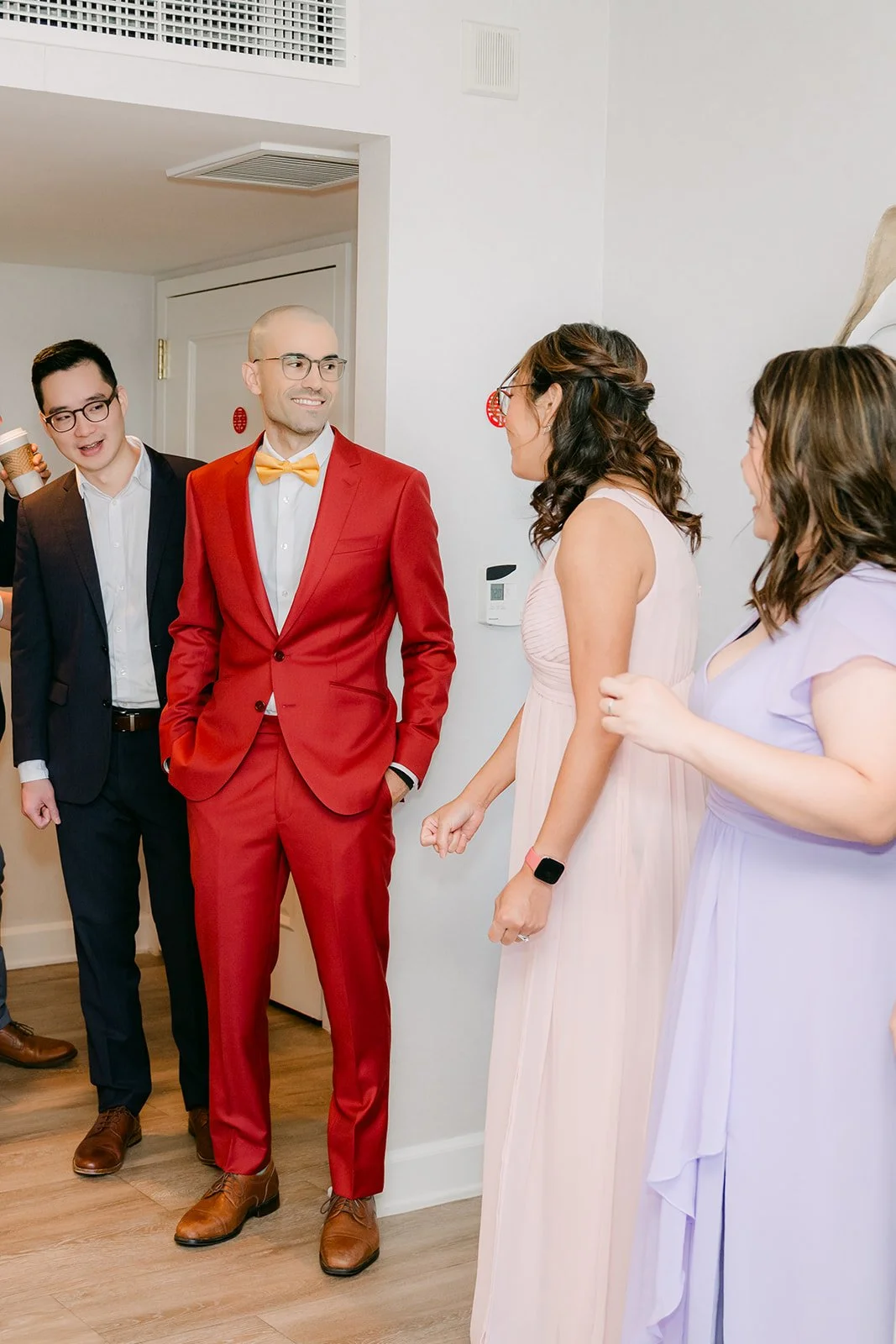 Christian and his friends facing Christie's bridesmaids at the door.