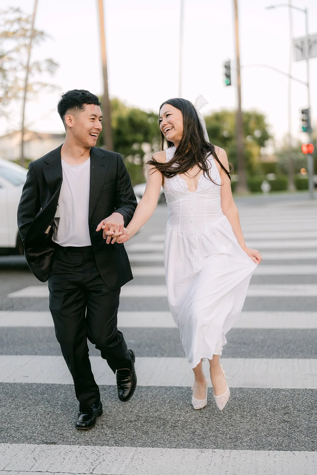Jadee and Richard laugh as they walk across the crosswalk.