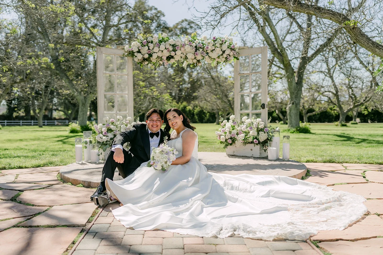 Couple sitting together in front of the floral doors