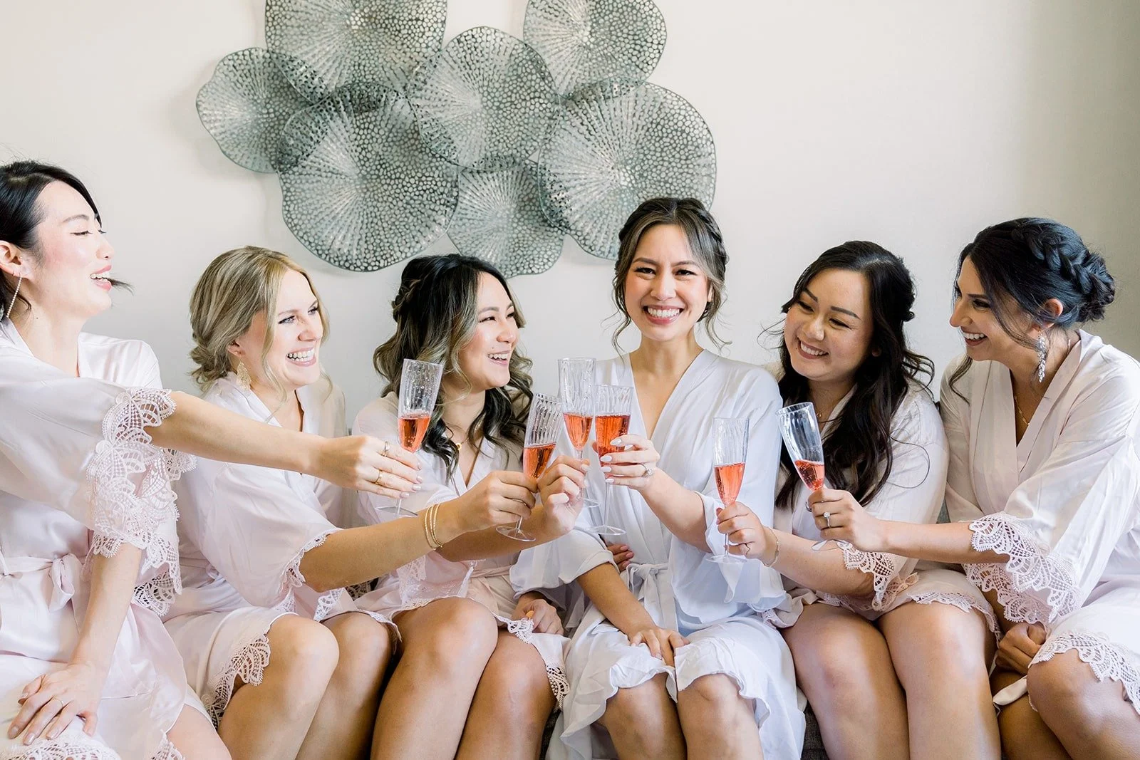 Josephine and her bridesmaids toasting in their robes