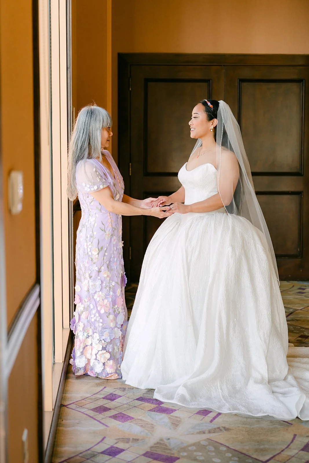 Angela holding hands with her mom