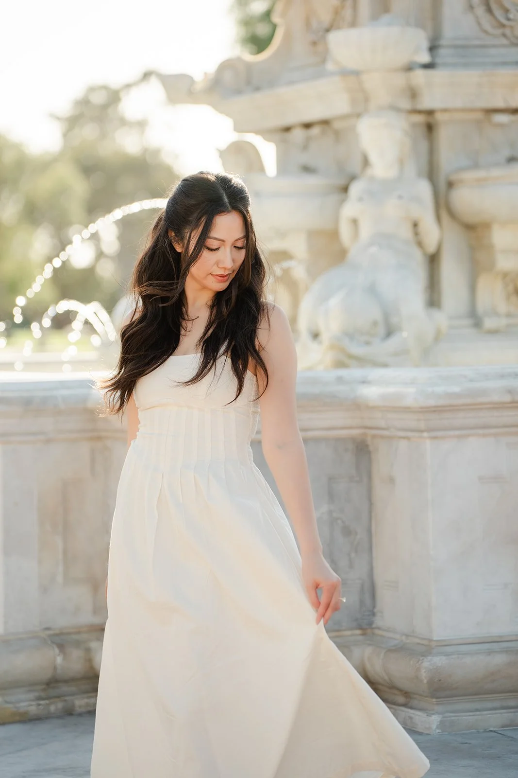 Victoria twirls her dress in front of the Malaga Cove fountain, photographed by One and Only Production.