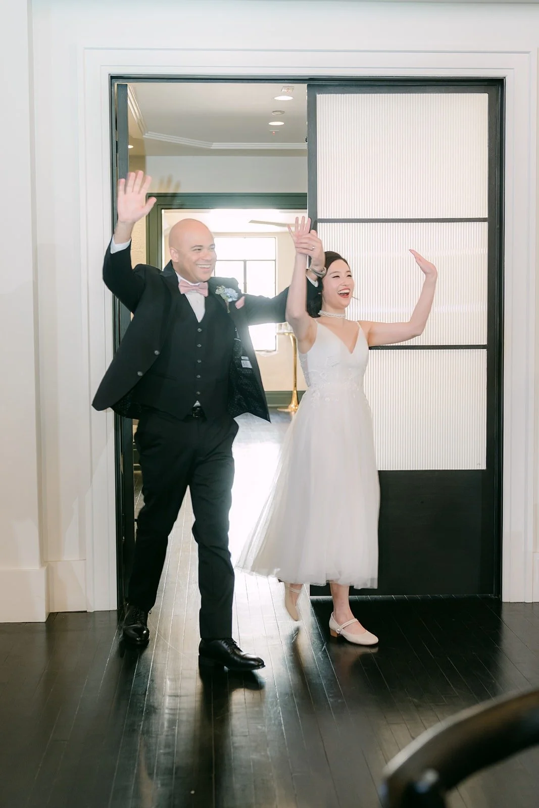 Elisa and Brandon wave as they make their grand entrance, Elisa in her second dress