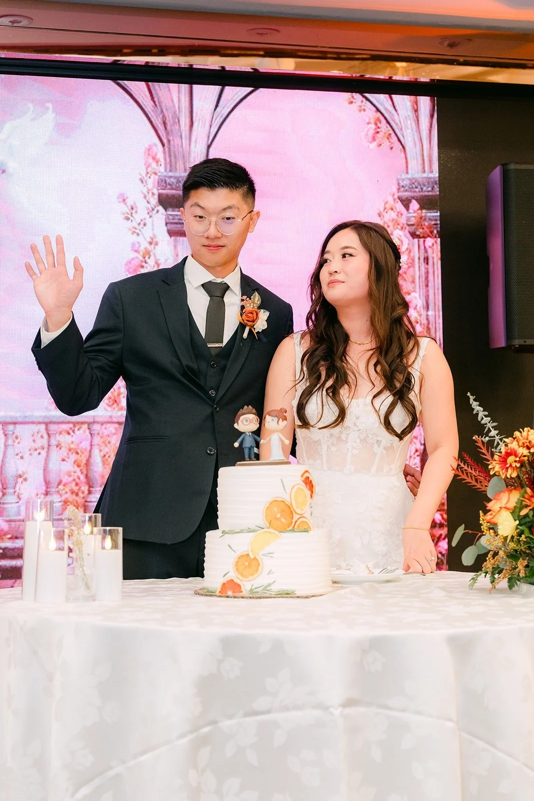 Shayna and Robert wave after cutting the cake, photographed by One and Only Production