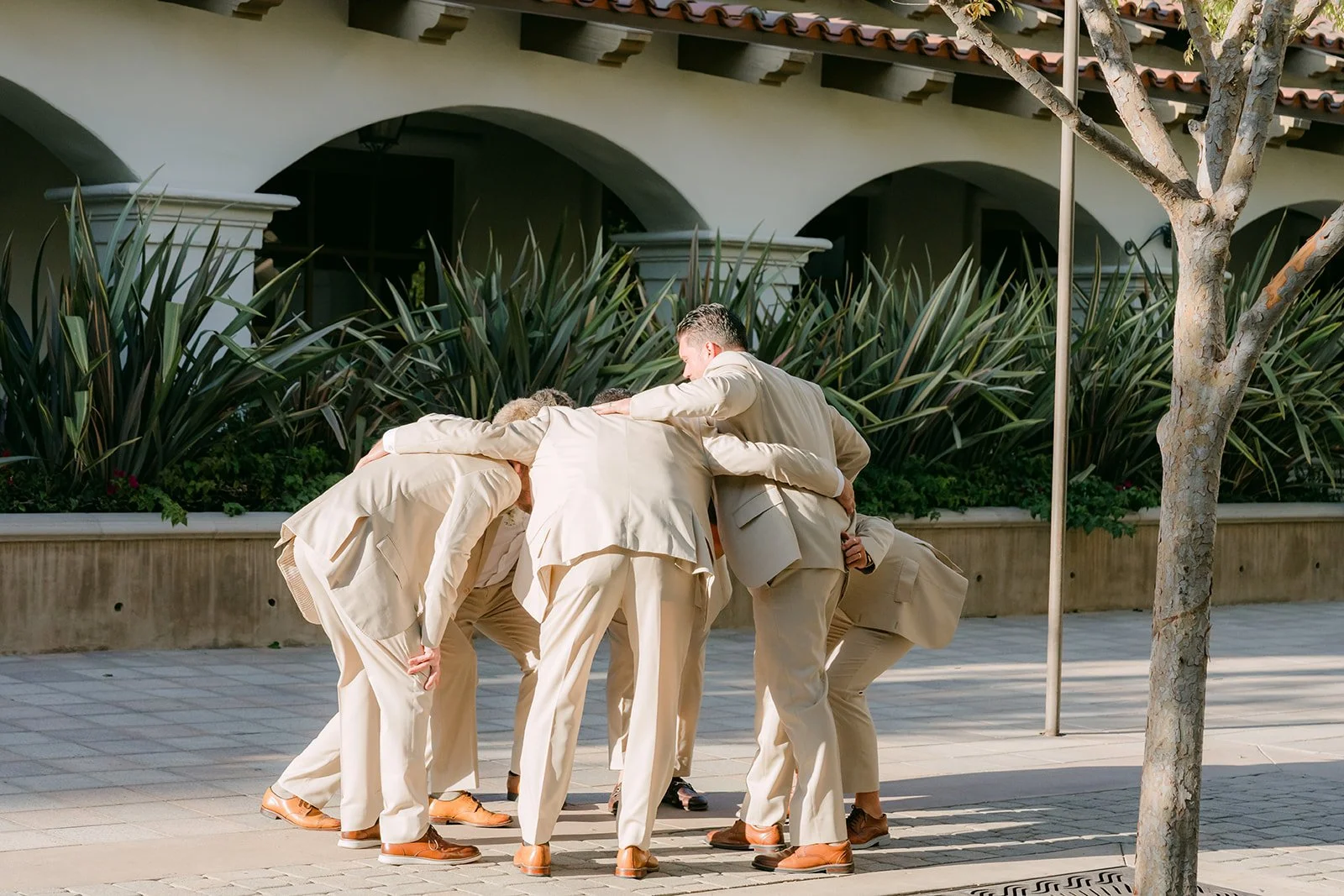 Groomsmen huddled together before their entrance