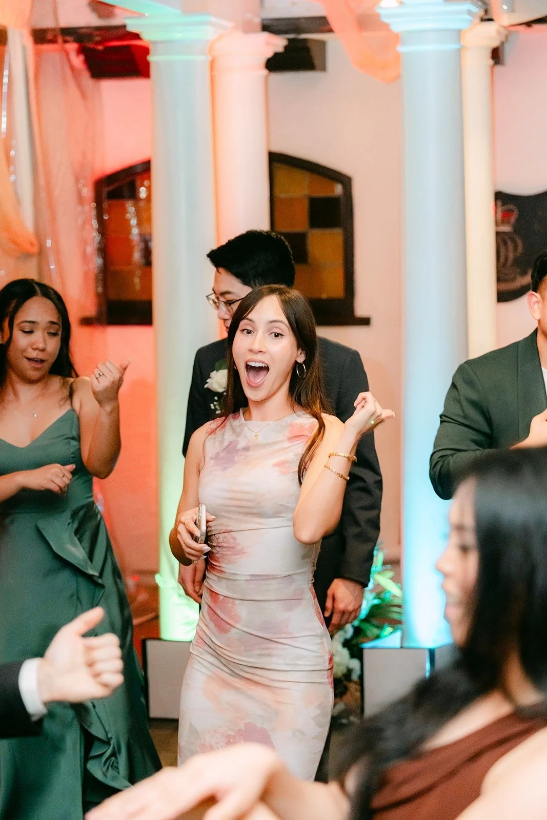 A bridesmaid mid shout on the dance floor