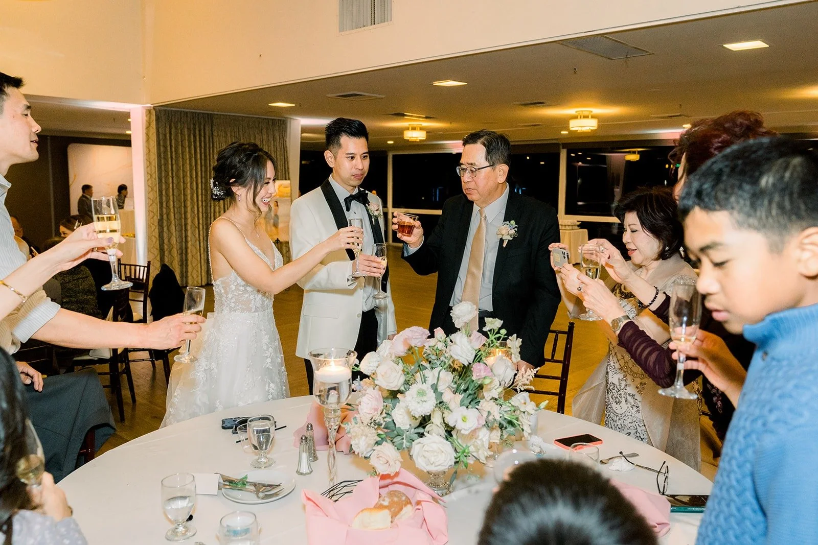 Guests raising their glasses at their table, photographed by One and Only Production