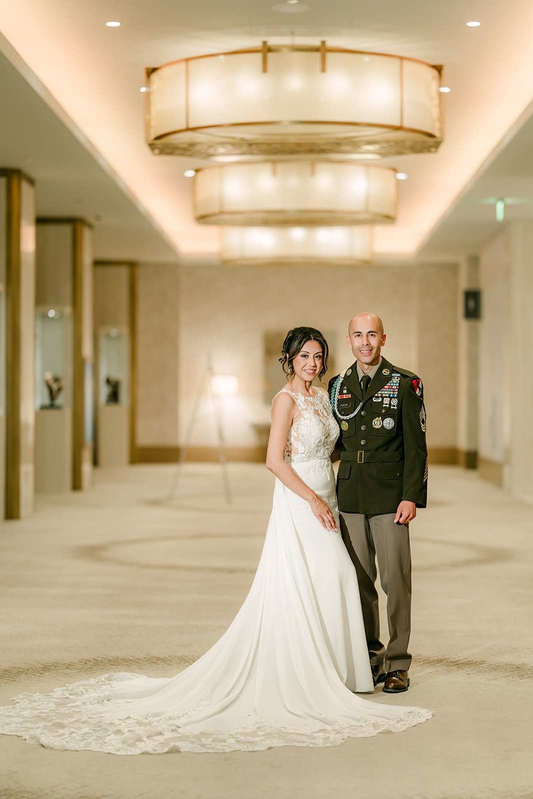 Francesca and Daniel in his uniform step into the Carousel Ballroom foyer