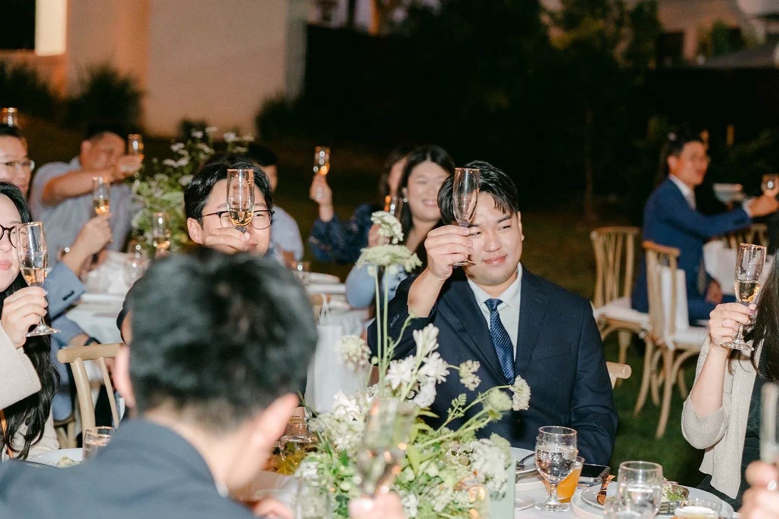 Guests raising their glasses during the toasts