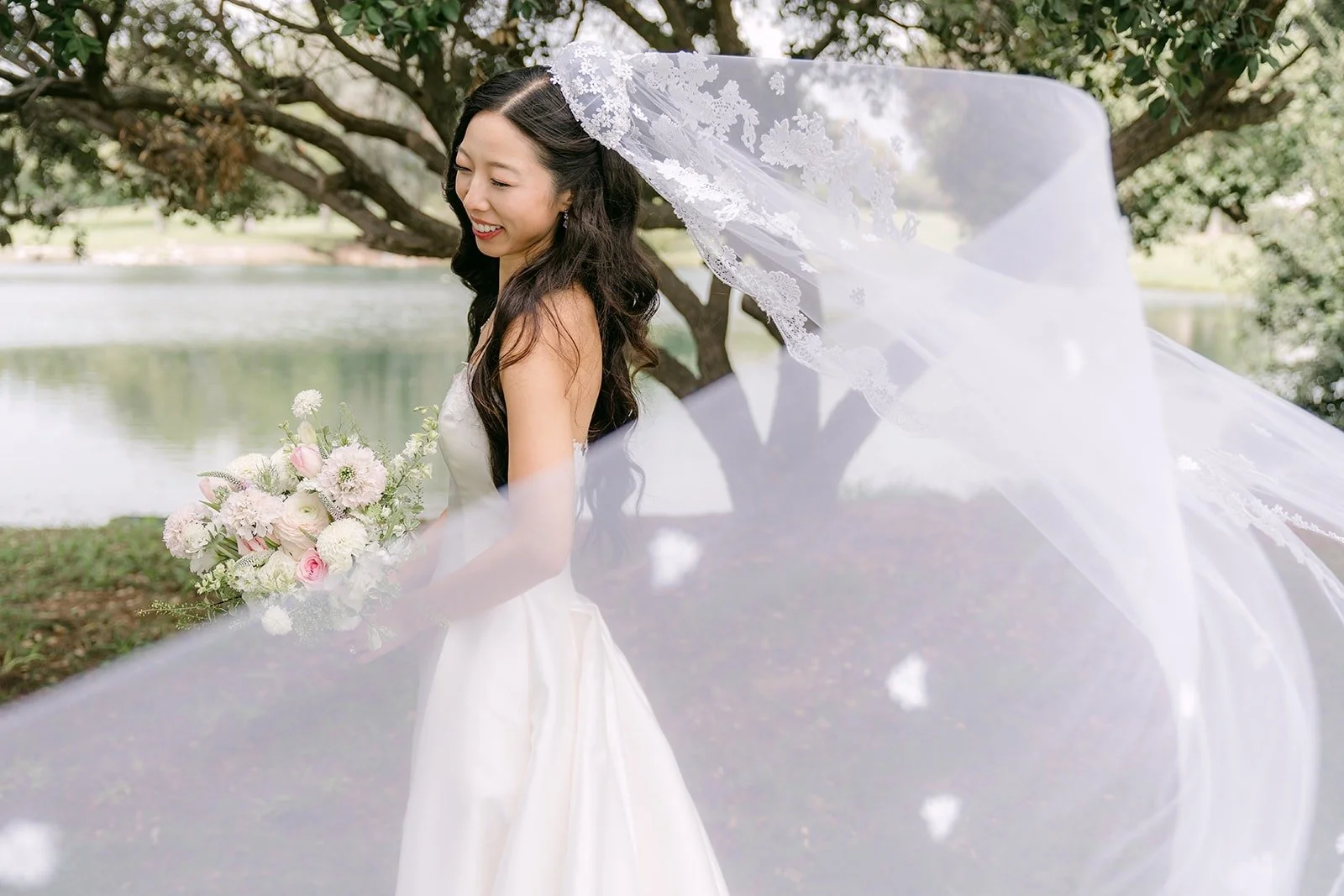 Kristine's long veil caught in the wind on the lawn