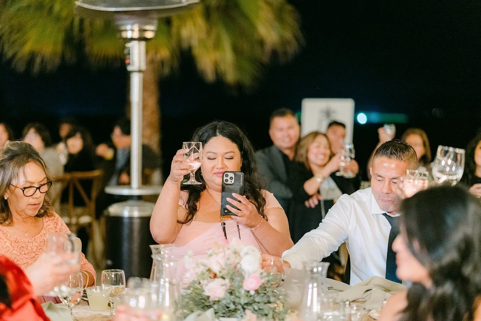 Guests at the long tables listening to a toast