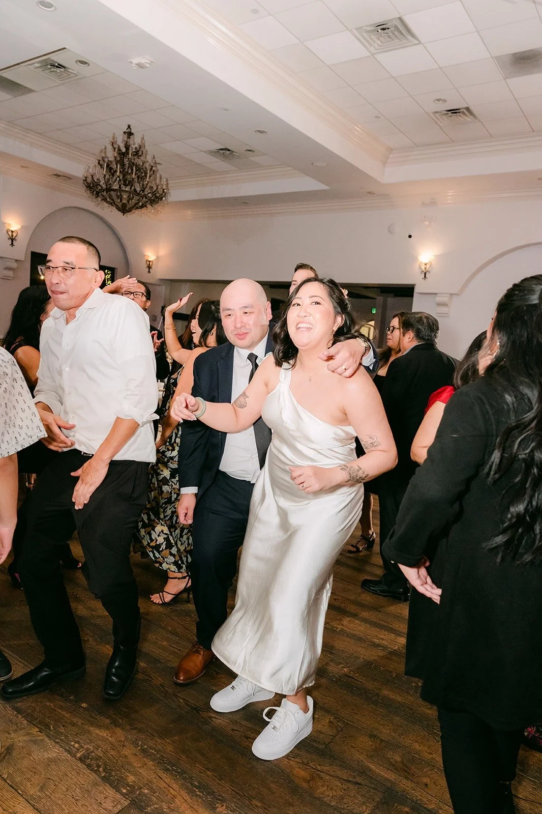 Vivian dancing with friends in her short reception dress