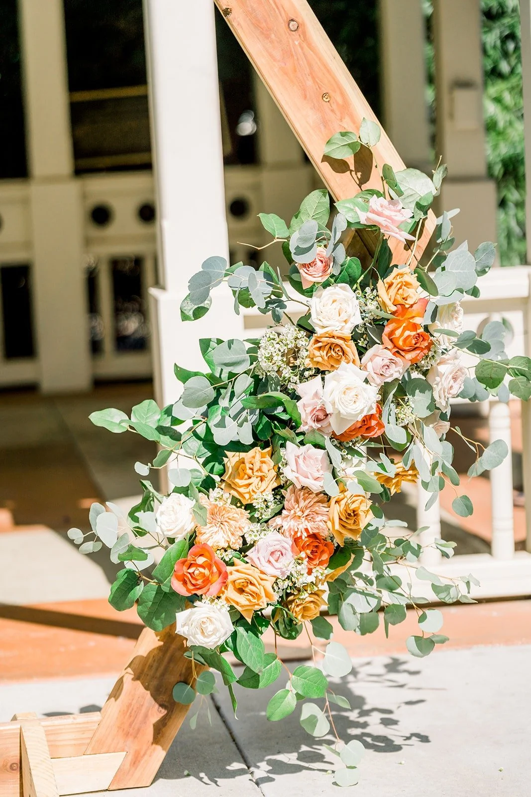 Peach and white florals on the ceremony arch