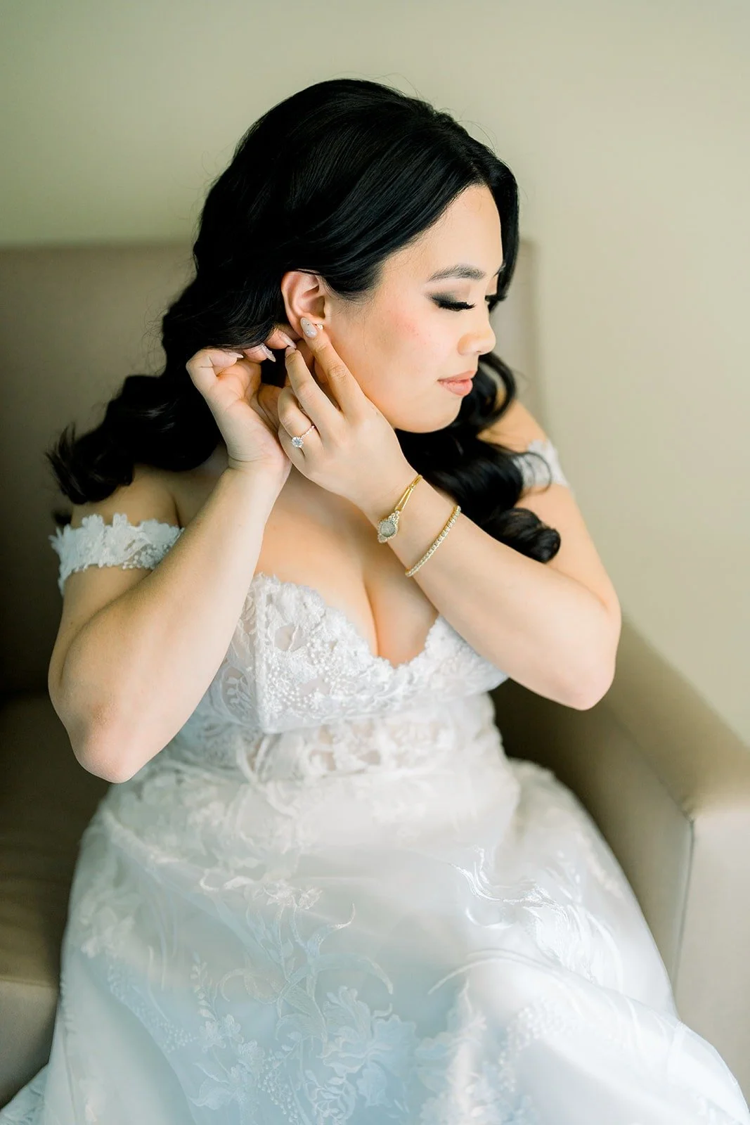 Francesca fastening her earring in the hotel suite