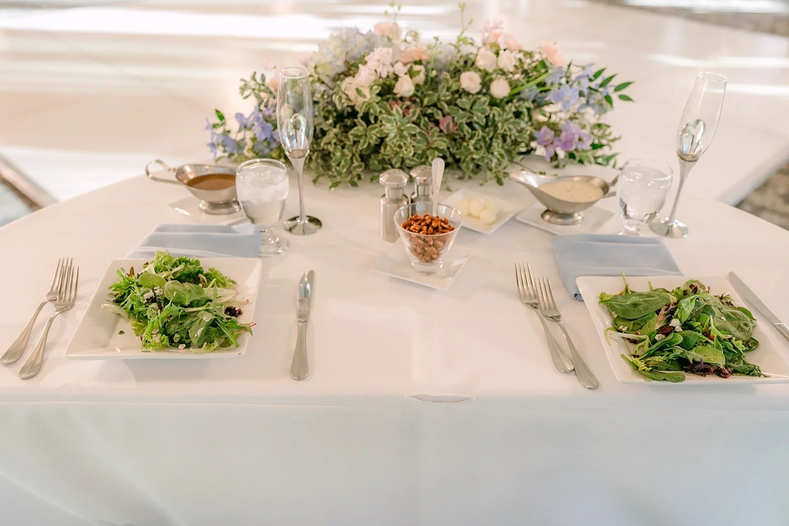 Place setting with linens and greenery at the sweetheart table
