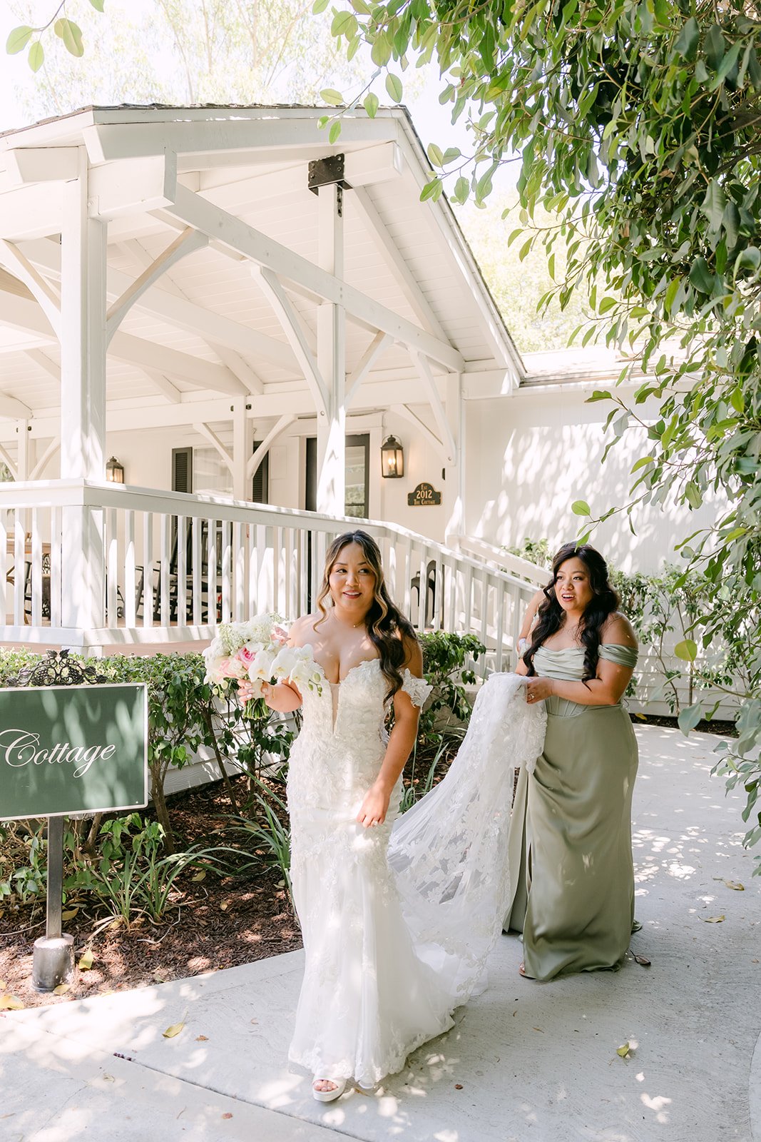 Nicole walking from the gazebo to her first look as a bridesmaid carries her train.
