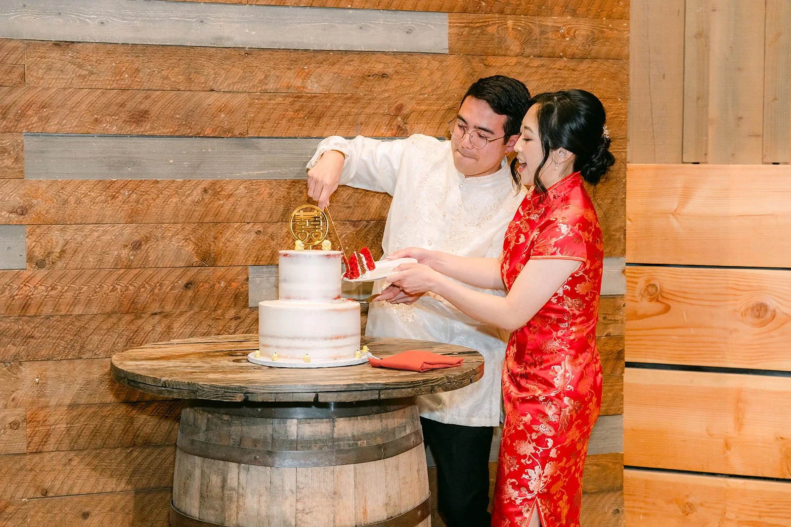 Couple cutting their wedding cake on a whiskey barrel