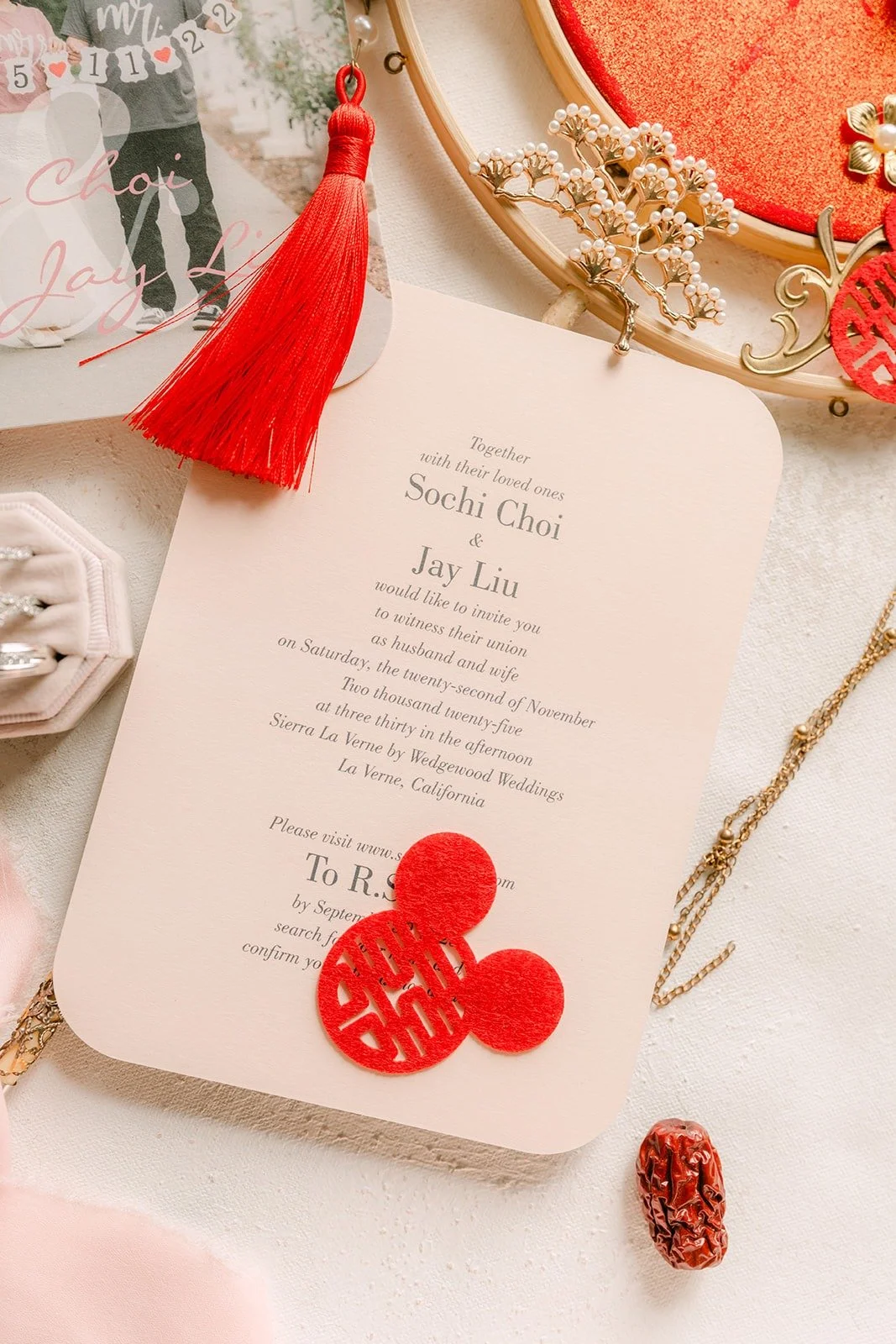 The invitation with a red tassel and gold hair pieces, photographed by One and Only Production