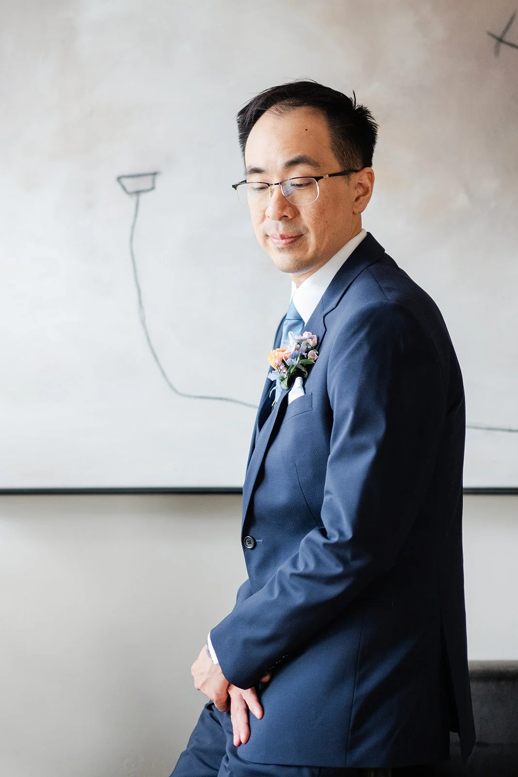 Portrait of Lawrence in his navy suit, photographed by One and Only Production