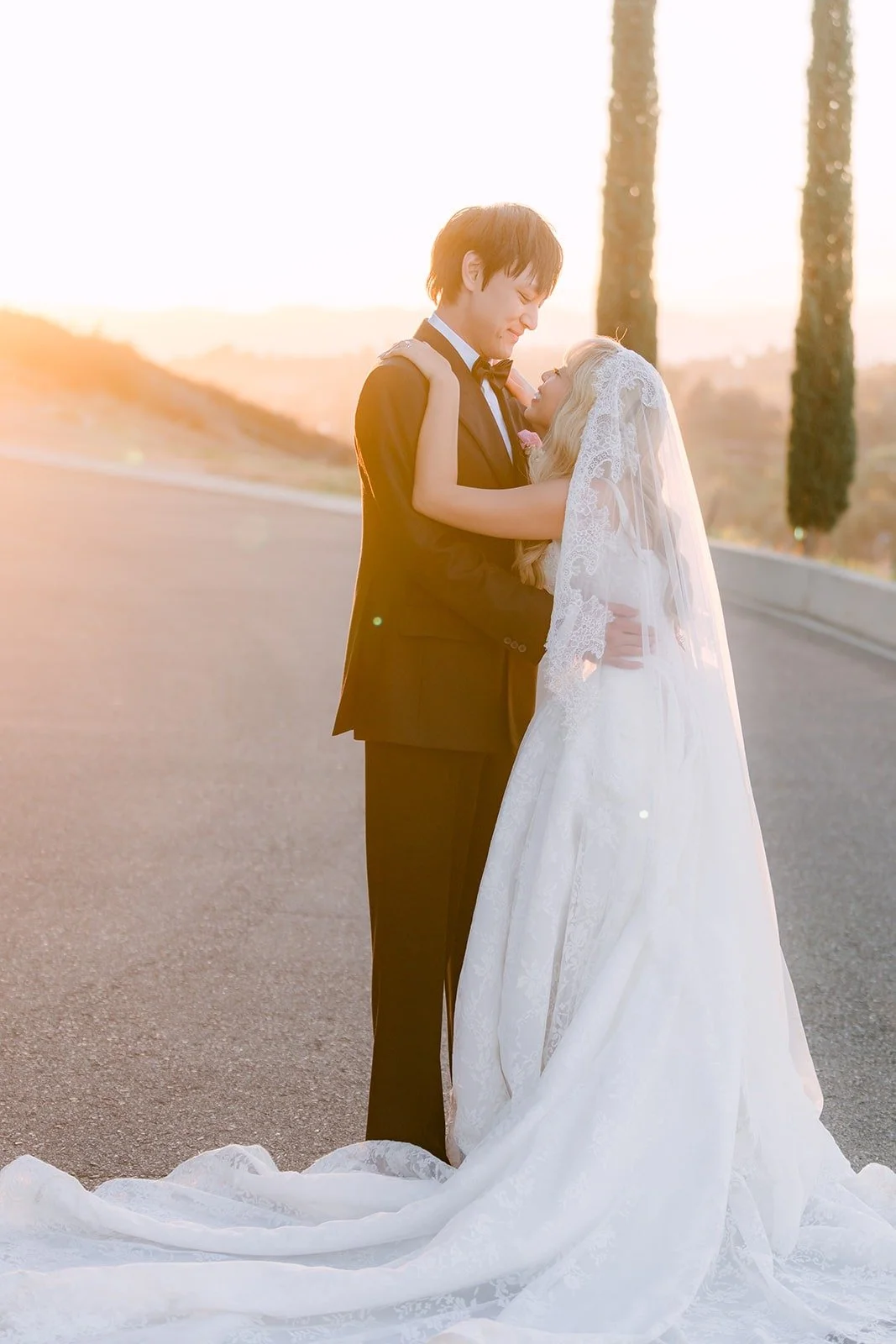 Konitha and Job on the cypress lined drive at sunset